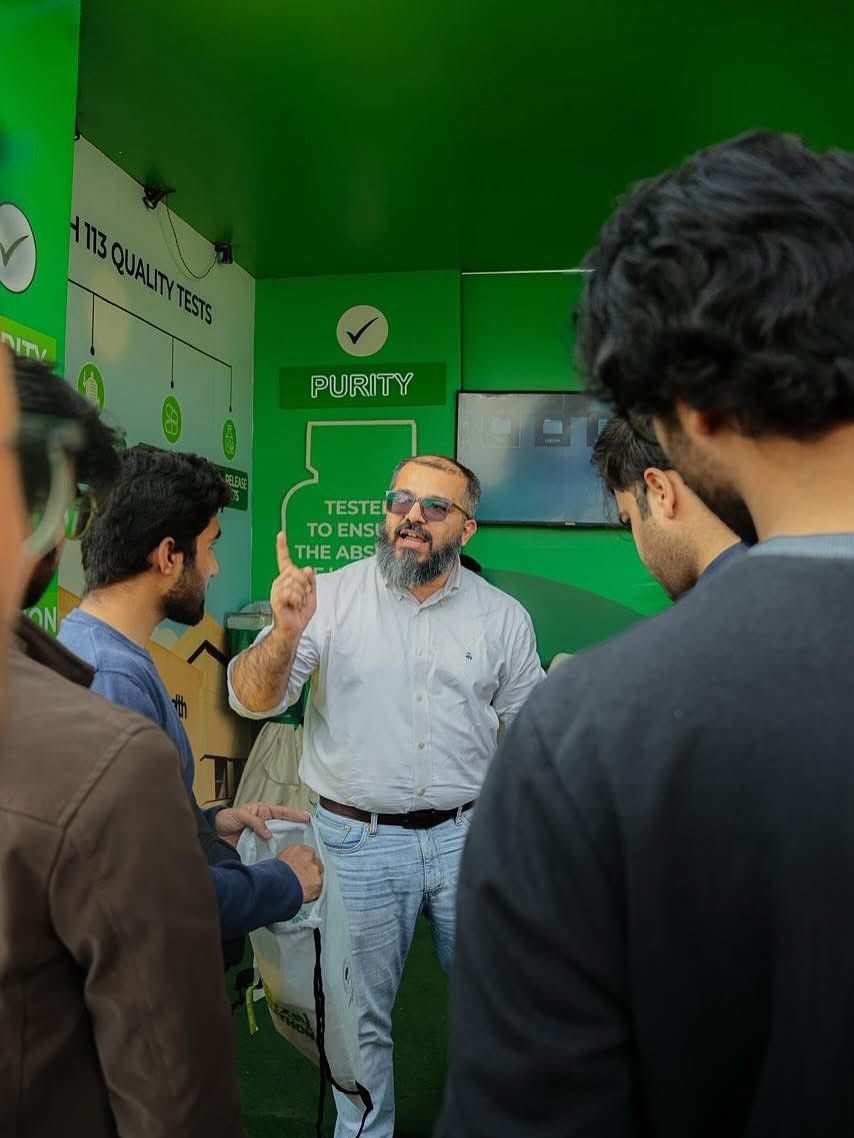 Visitors at a green product-testing stall in the Marathon Village